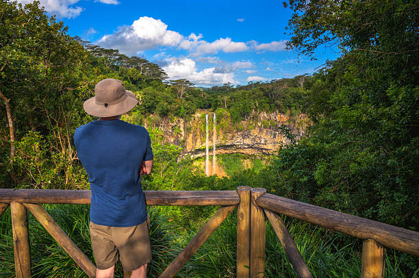 Hikers on a trail through the lush green mountains of Mauritius
