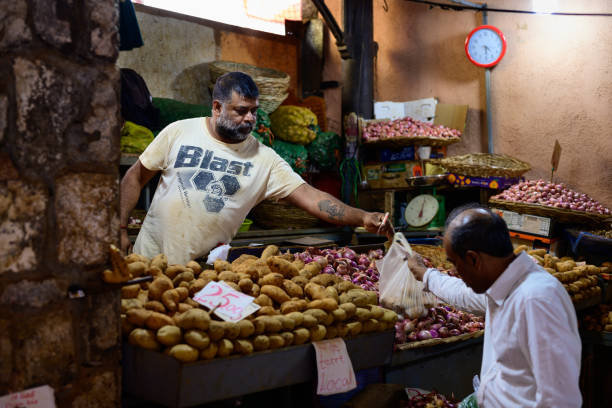 A busy local market in Mauritius with stalls selling tropical fruits, spices and handmade goods