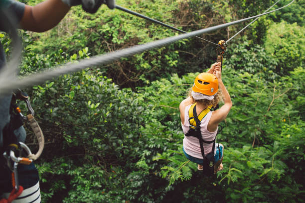 A person zip-lining over a lush green valley in Mauritius